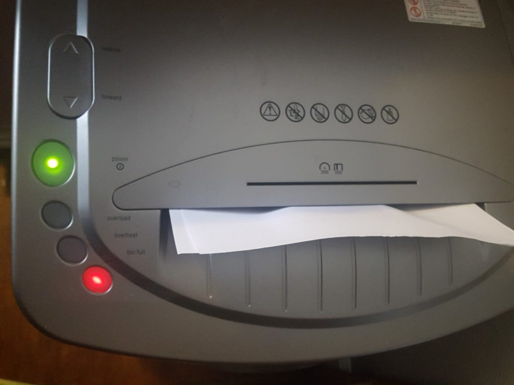 Bright red light shows the shredder is full, causing the paper to jam. Even though the green light is on, the shredder doesn't work.
